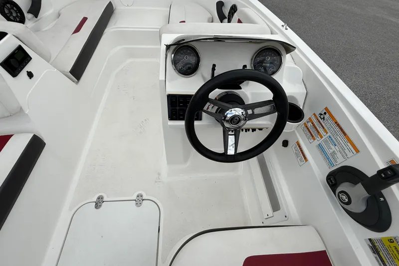 Slide: The Image of 2023 Hurricane SunDeck Sport 185 OB boat cockpit with steering wheel and control panel. - 16