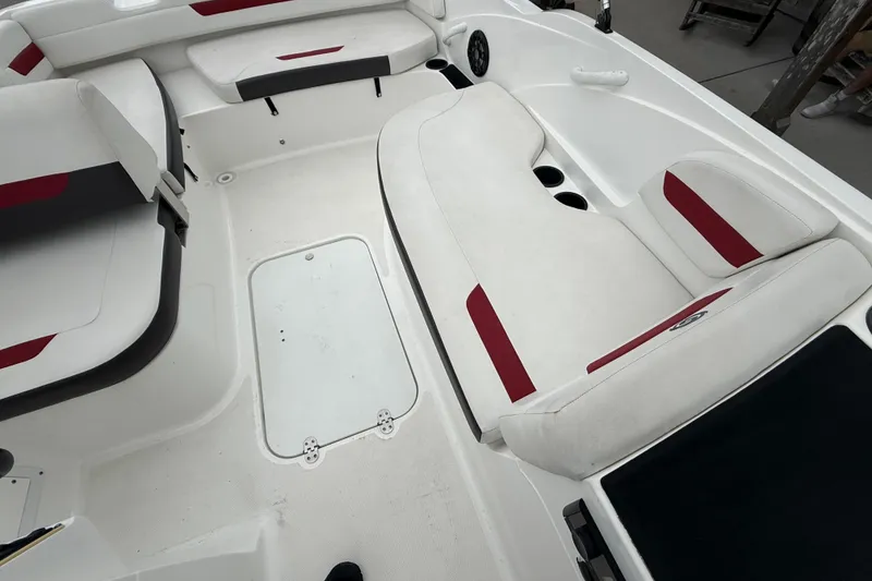 Slide: The Image of 2023 Hurricane SunDeck Sport 185 OB interior with white and red seating, spacious layout. - 17