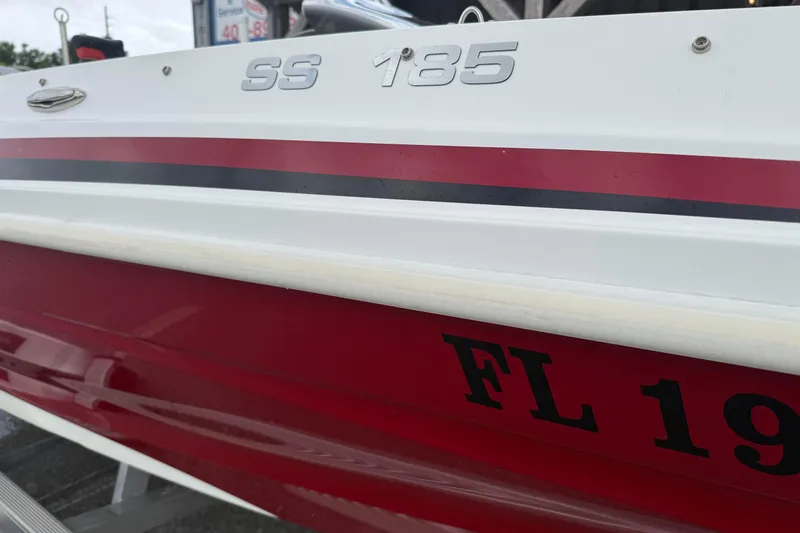 Slide: The Image of 2023 Hurricane SunDeck Sport 185 OB boat with red and white exterior detailing. - 3