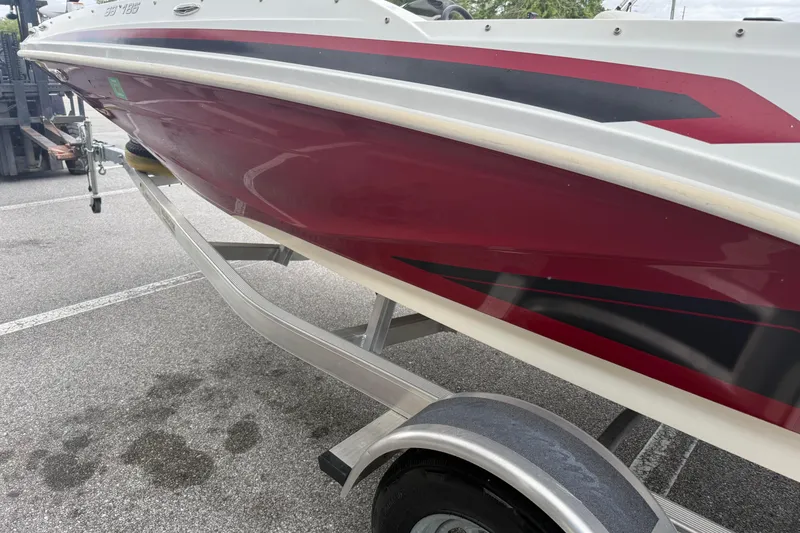 Slide: The Image of 2023 Hurricane SunDeck Sport 185 OB boat on trailer, red and white design. - 7