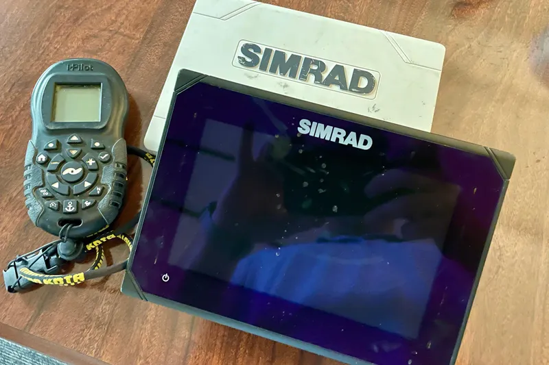 Slide: The Image of Simrad marine electronics and iPilot remote on a wooden surface, Bulls Bay 2000, 2016 model. - 16