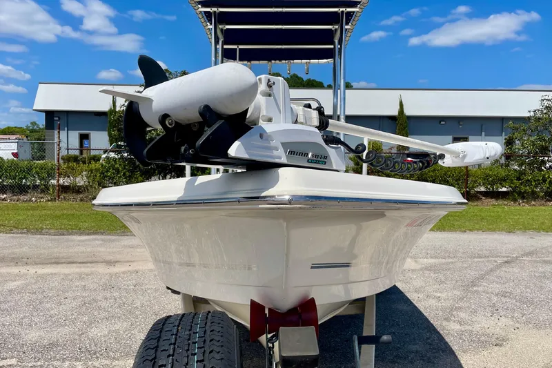 Slide: The Image of 2016 Bulls Bay 2000 boat with Minn Kota trolling motor, parked outdoors under blue sky. - 3