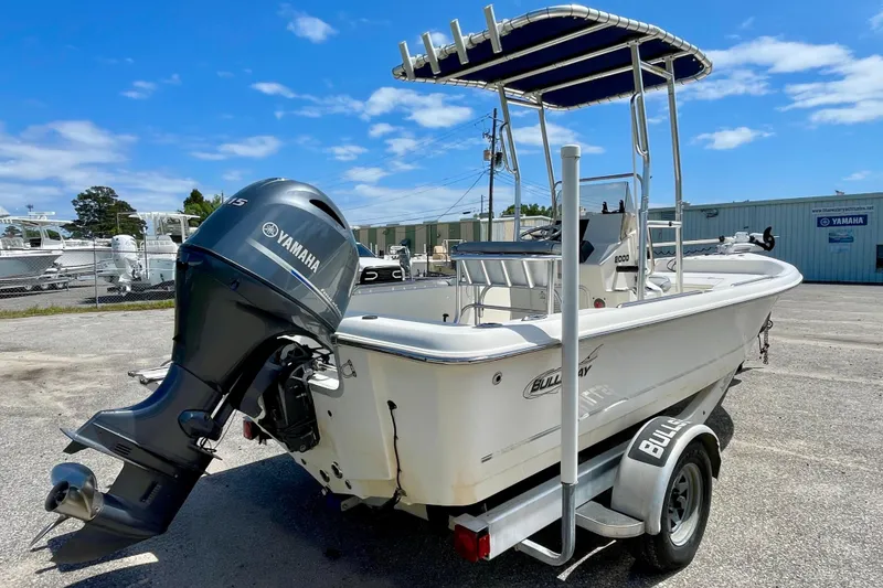 Slide: The Image of 2016 Bulls Bay 2000 boat with Yamaha outboard motor on trailer, parked outdoors. - 6