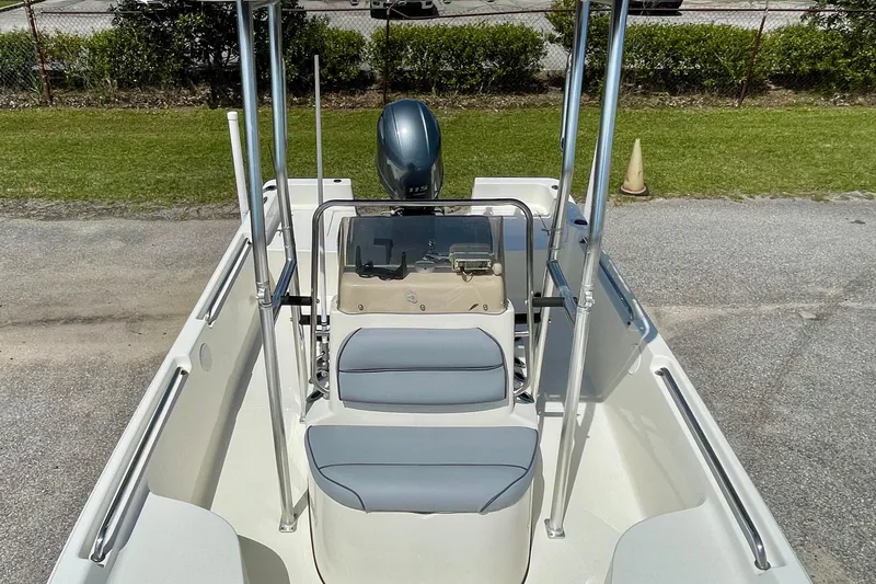 Slide: The Image of 2016 Bulls Bay 2000 boat interior with seating and console, parked on pavement. - 9