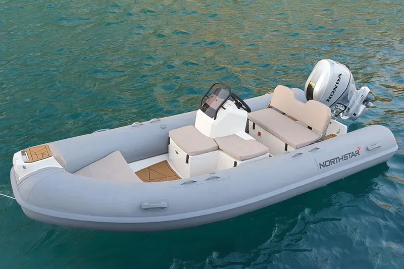 The Image of 2026 Northstar VEGA 4.2 inflatable boat on water, featuring Honda outboard motor. - 1