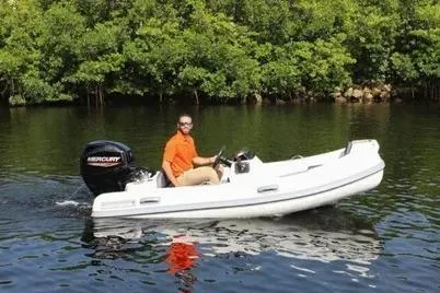 Slide: The Image of Man driving Northstar Vega 4.2 boat with Yamaha 50HP engine on a calm river. - 8