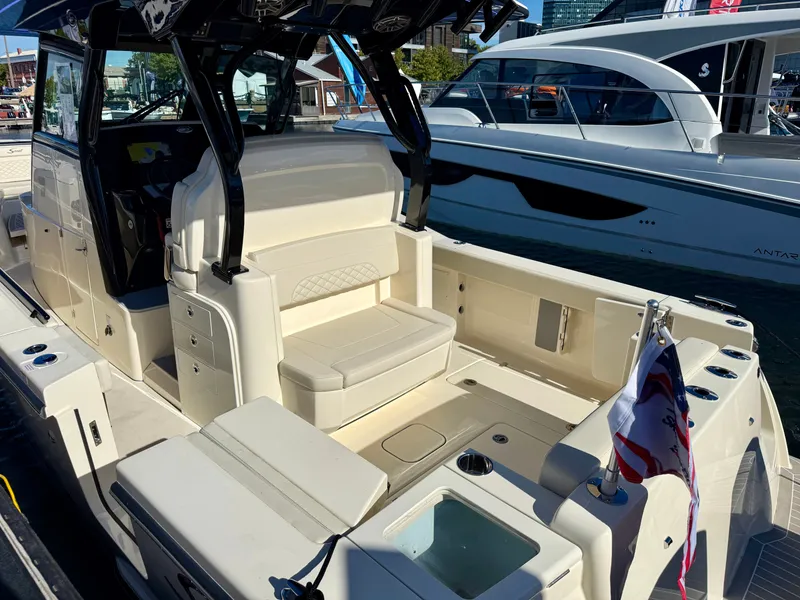 Slide: The Image of Scout 330 LXF 2027: Luxurious boat with beige seating area and modern features docked in a marina. - 5