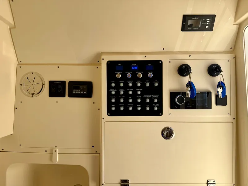 Slide: The Image of The image shows the dashboard of a Scout 330 LXF boat with various controls and switches. - 19