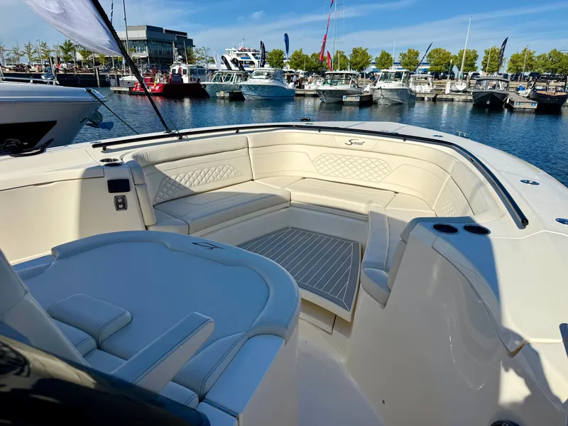 Slide: The Image of The image shows the cockpit of a Scout 330 LXF boat in a marina, surrounded by other boats. - 11