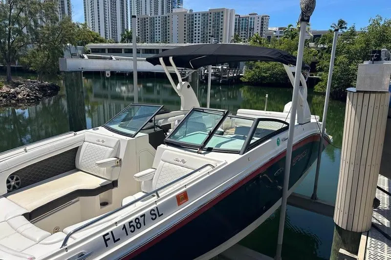 Slide: The Image of 2019 Sea Ray SDX 270 Outboard boat docked near waterfront buildings. - 2