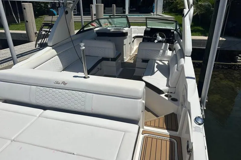 Slide: The Image of 2019 Sea Ray SDX 270 Outboard boat interior with white seating and modern design. - 4