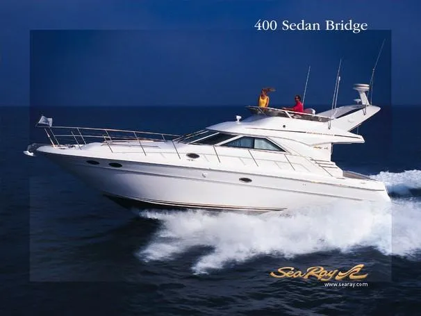The Image of 2003 Sea Ray 400 Sedan Bridge yacht on dry dock under cloudy skies. - 0