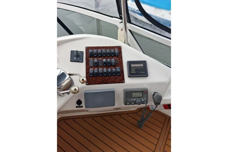 Slide: The Image of Control panel of a 2003 Sea Ray 400 Sedan Bridge yacht with switches and navigation equipment. - 17