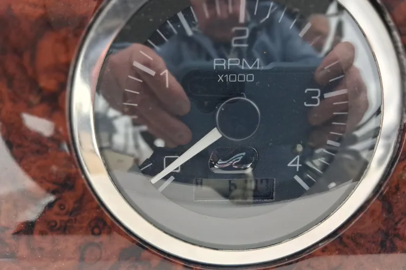 Slide: The Image of Close-up of a 2003 Sea Ray 400 Sedan Bridge RPM gauge, reflecting a person taking a photo. - 20