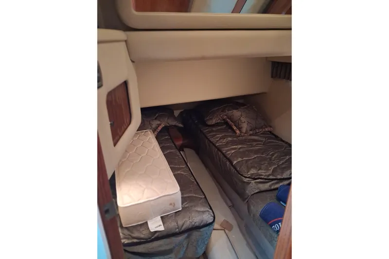 Slide: The Image of Interior cabin of 2003 Sea Ray 400 Sedan Bridge with twin beds and bedding. - 22