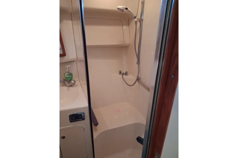 Slide: The Image of Bathroom interior of 2003 Sea Ray 400 Sedan Bridge yacht, featuring shower and sink. - 23
