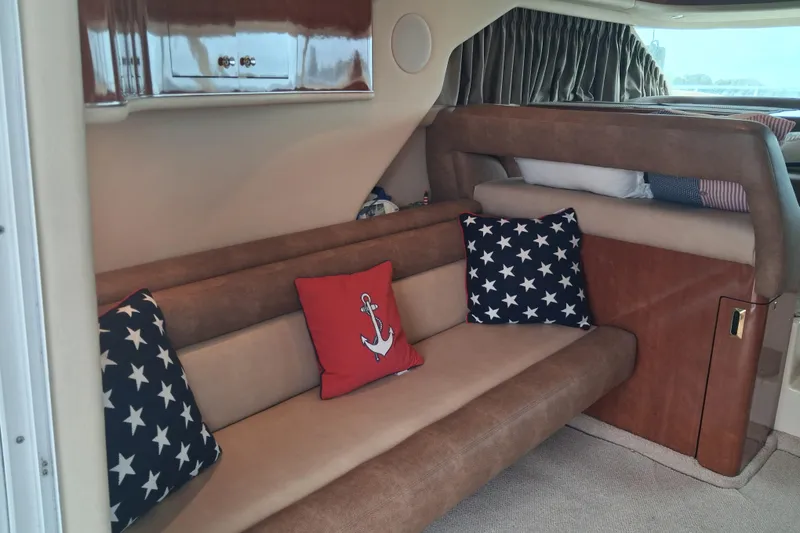 Slide: The Image of Interior of 2003 Sea Ray 400 Sedan Bridge with nautical-themed cushions and cozy seating. - 26