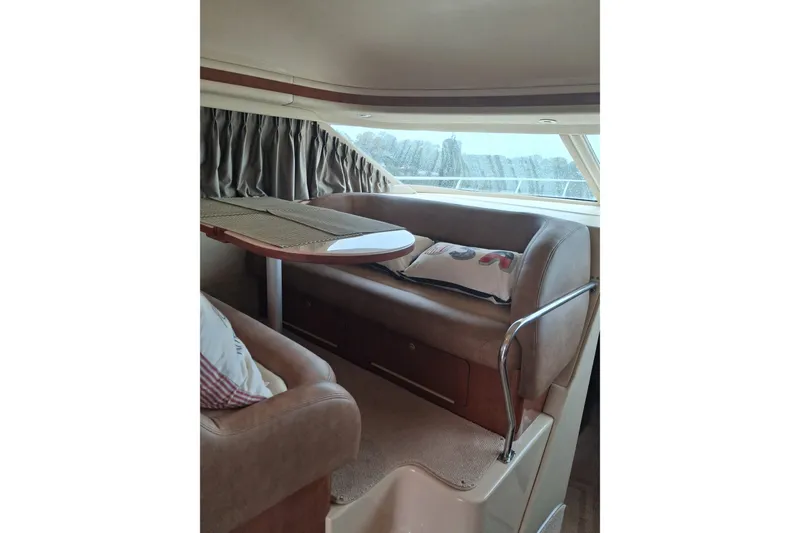 Slide: The Image of Interior of 2003 Sea Ray 400 Sedan Bridge with cozy seating and table. - 29