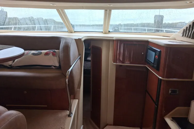 Slide: The Image of Interior of 2003 Sea Ray 400 Sedan Bridge yacht, featuring seating and navigation area. - 30
