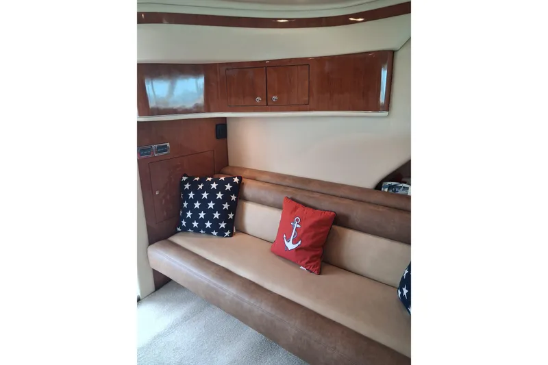 Slide: The Image of Luxurious interior of 2003 Sea Ray 400 Sedan Bridge with nautical-themed cushions. - 31