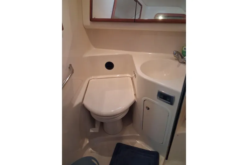 Slide: The Image of Bathroom interior of 2003 Sea Ray 400 Sedan Bridge yacht, featuring toilet and sink. - 35
