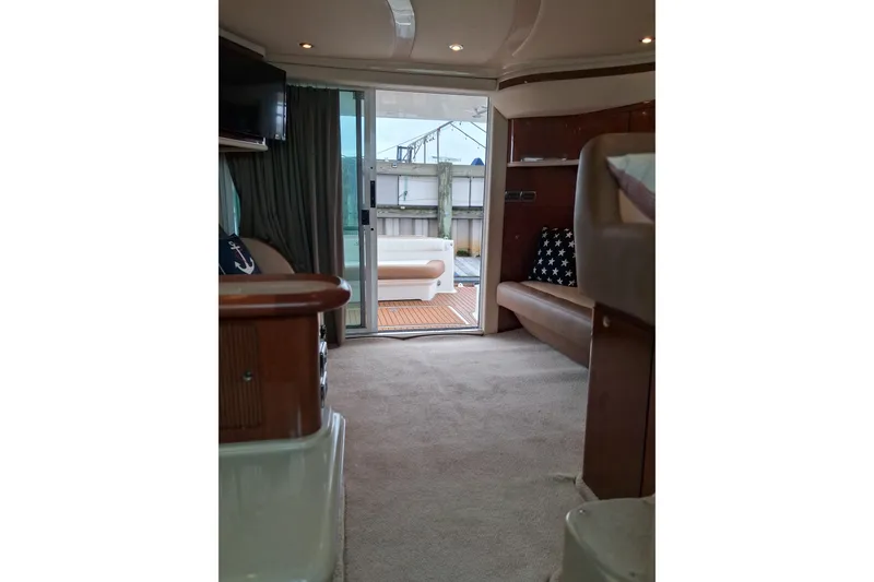 Slide: The Image of Interior of 2003 Sea Ray 400 Sedan Bridge yacht, featuring cozy seating and elegant decor. - 38
