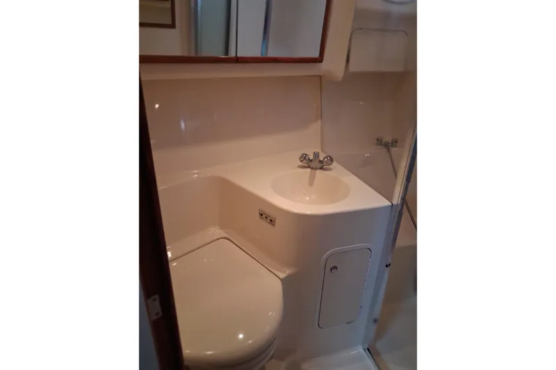 Slide: The Image of Bathroom interior of 2003 Sea Ray 400 Sedan Bridge yacht, featuring sink and toilet. - 41