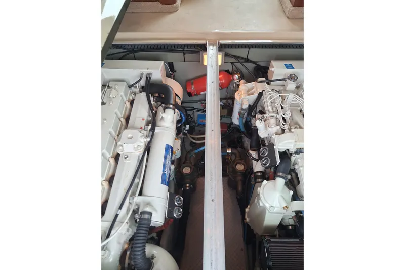 Slide: The Image of Engine compartment of a 2003 Sea Ray 400 Sedan Bridge, showcasing dual engines and components. - 43