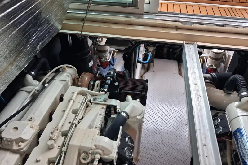 Slide: The Image of Engine room of a 2003 Sea Ray 400 Sedan Bridge yacht, showcasing mechanical components. - 46