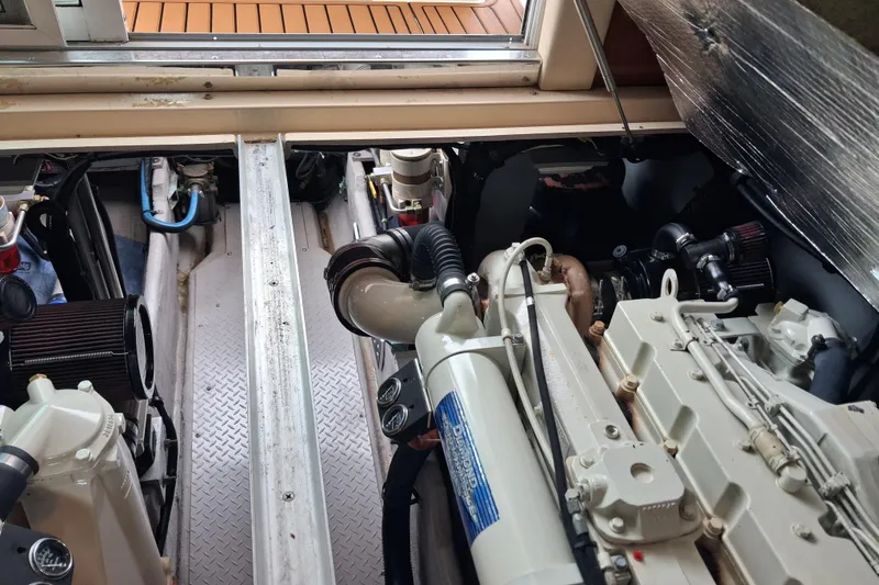Slide: The Image of Engine compartment of a 2003 Sea Ray 400 Sedan Bridge yacht, showcasing mechanical components. - 47