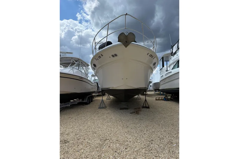 Slide: The Image of 2003 Sea Ray 400 Sedan Bridge yacht on dry dock under cloudy sky. - 5