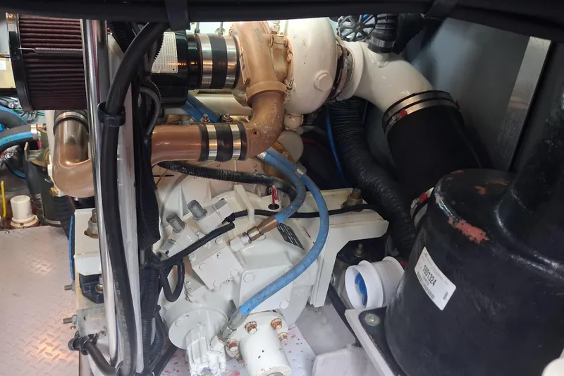 Slide: The Image of Engine room of a 2003 Sea Ray 400 Sedan Bridge with visible mechanical components. - 50