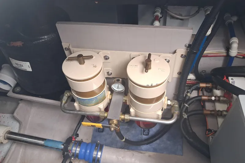 Slide: The Image of Engine room of 2003 Sea Ray 400 Sedan Bridge with fuel filters and piping. - 51