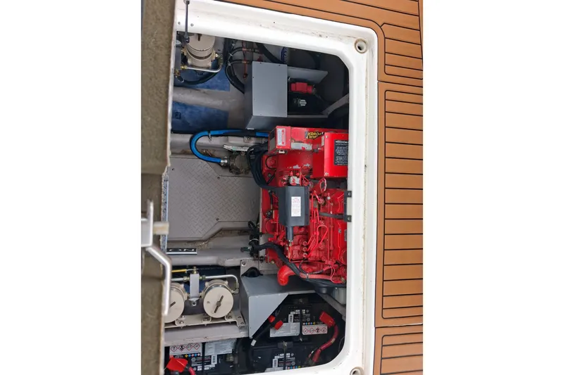 Slide: The Image of Engine compartment of a 2003 Sea Ray 400 Sedan Bridge boat, featuring red machinery. - 52