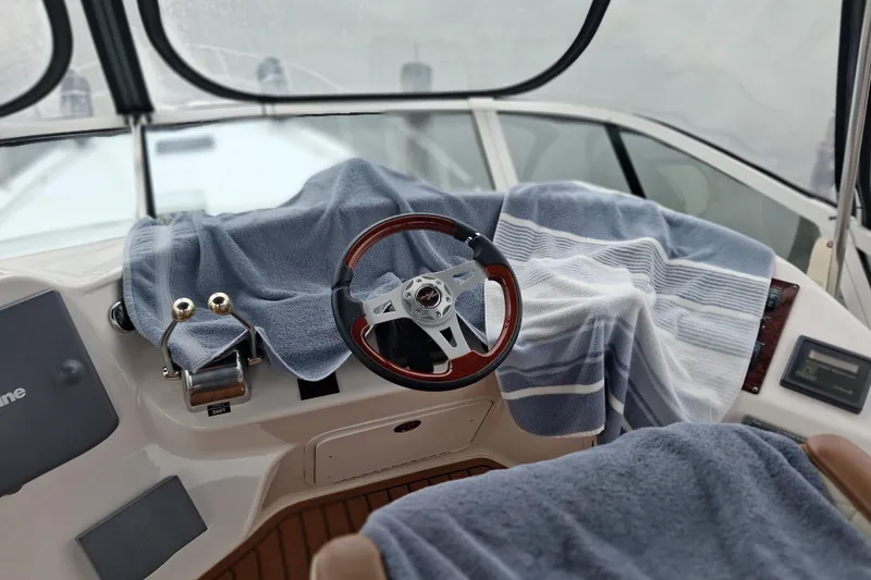 Slide: The Image of Cockpit of 2003 Sea Ray 400 Sedan Bridge with towels covering controls. - 53