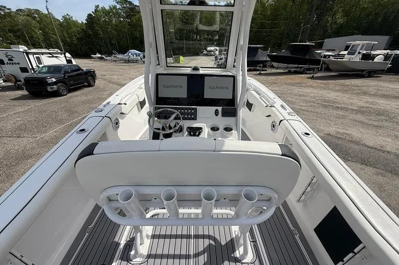Slide: The Image of 2022 Tidewater 272 LXF boat interior with dual Garmin displays and rod holders. - 14