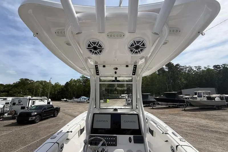 Slide: The Image of 2022 Tidewater 272 LXF boat interior with Garmin displays and overhead speakers. - 15