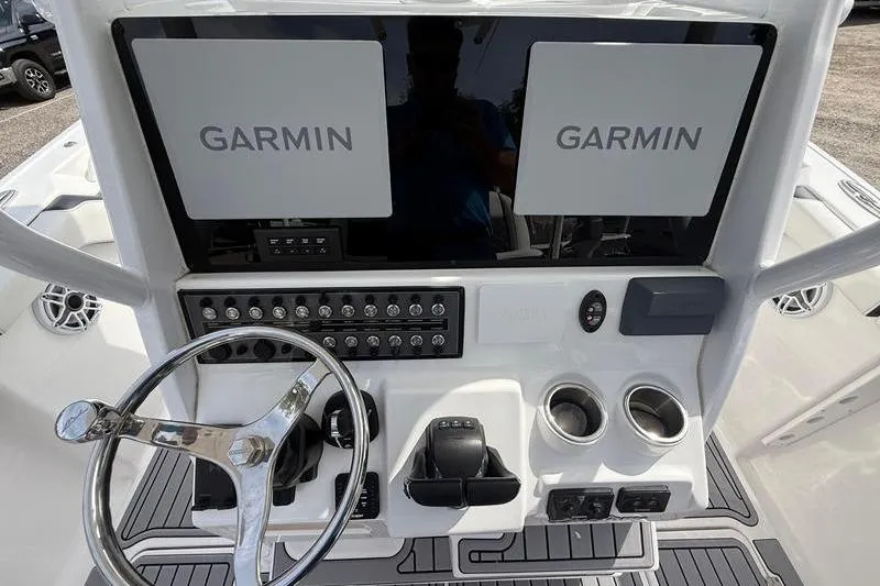 Slide: The Image of Control panel of 2022 Tidewater 272 LXF boat with Garmin displays and steering wheel. - 18