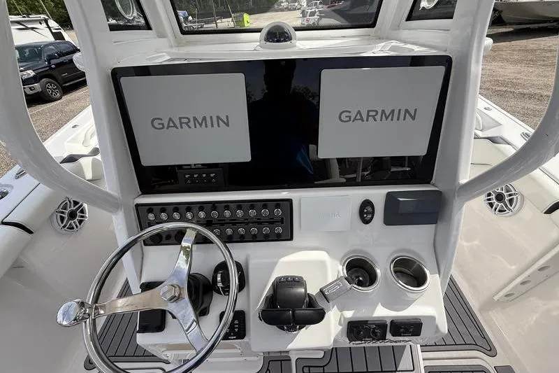 Slide: The Image of 2022 Tidewater 272 LXF boat dashboard with dual Garmin displays and steering wheel. - 24
