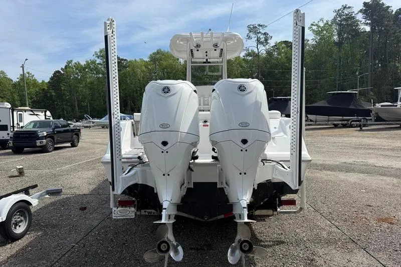Slide: The Image of 2022 Tidewater 272 LXF boat with dual outboard engines in a parking lot. - 3