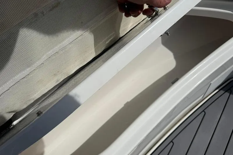 Slide: The Image of Storage compartment of a 2022 Tidewater 272 LXF boat, showcasing interior details. - 33