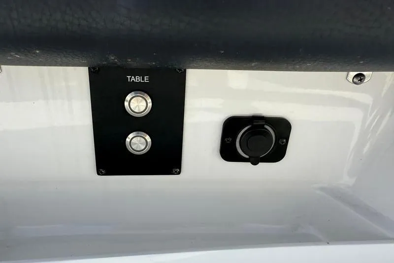 Slide: The Image of Control panel on 2022 Tidewater 272 LXF boat with table buttons and socket. - 34