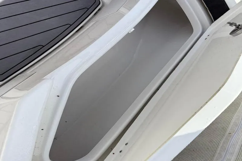 Slide: The Image of 2022 Tidewater 272 LXF boat storage compartment, open and empty, with sleek design. - 35