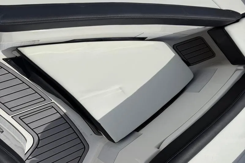 Slide: The Image of 2022 Tidewater 272 LXF boat interior with sleek seating and storage compartment. - 37