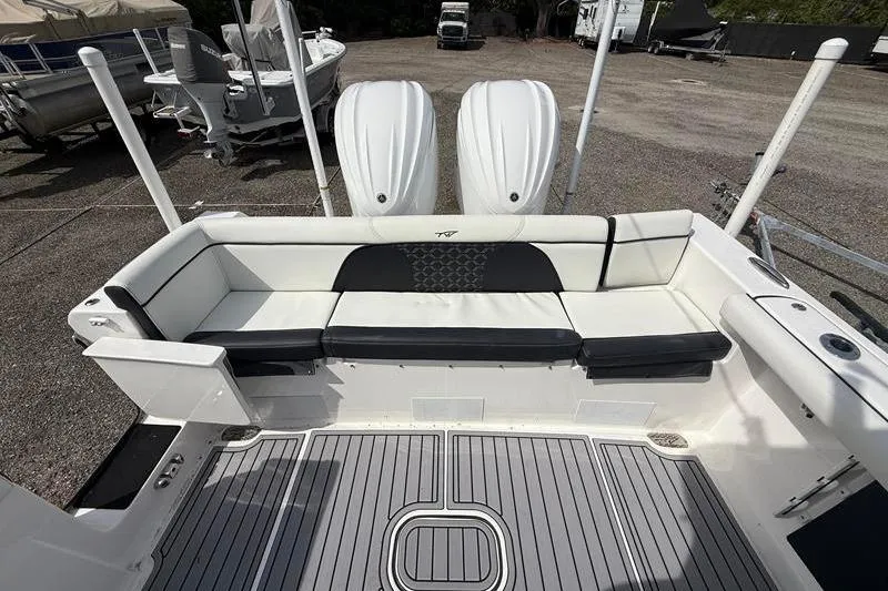 Slide: The Image of 2022 Tidewater 272 LXF boat interior with seating and twin engines. - 9