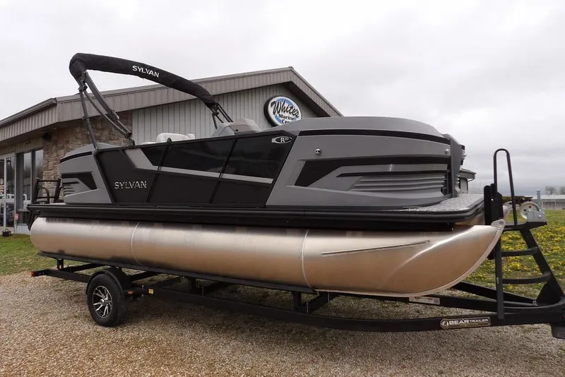 The Image of 2026 Sylvan R-20 CLZ DH pontoon boat on trailer outside dealership. - 1