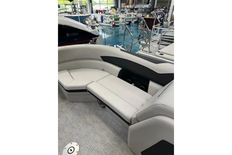 Slide: The Image of 2026 Berkshire 24RFX LE boat interior with luxurious seating in a showroom setting. - 12