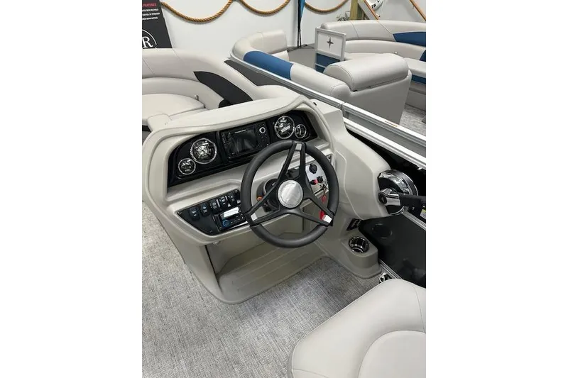 Slide: The Image of 2026 Berkshire 24RFX LE boat interior with steering wheel and dashboard controls. - 14