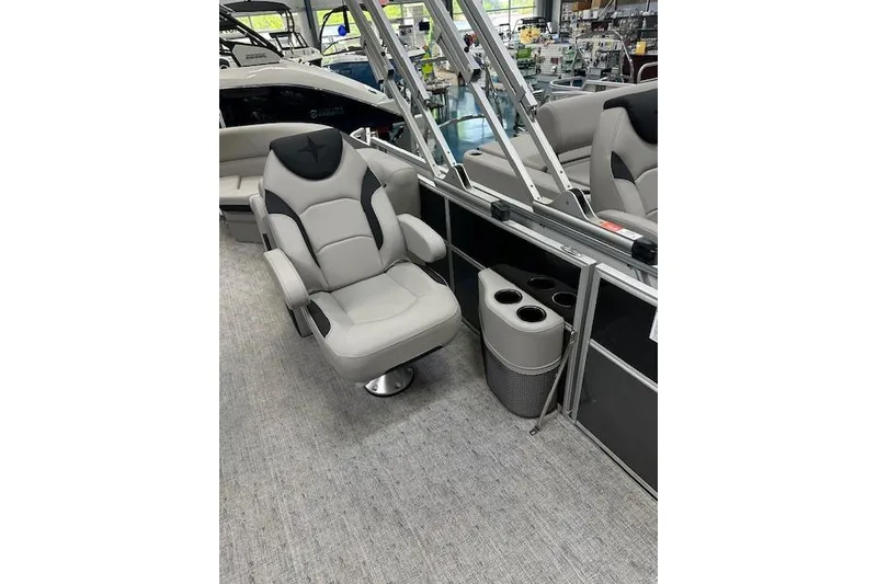 Slide: The Image of 2026 Berkshire 24RFX LE boat interior with plush captain's chair and cup holders. - 16