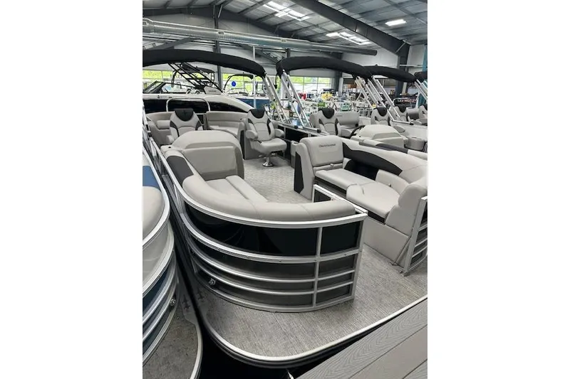 Slide: The Image of 2026 Berkshire 24RFX LE pontoon boat with luxurious seating in a showroom. - 19